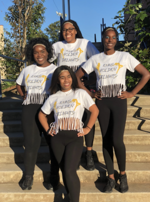 Four members of the dance team pose before a performance.