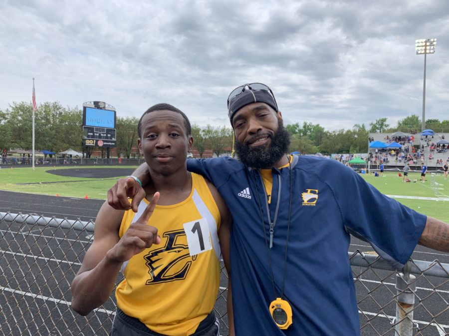 Senior athlete Kyle Goodman poses with Coach Hunter after 800M win.