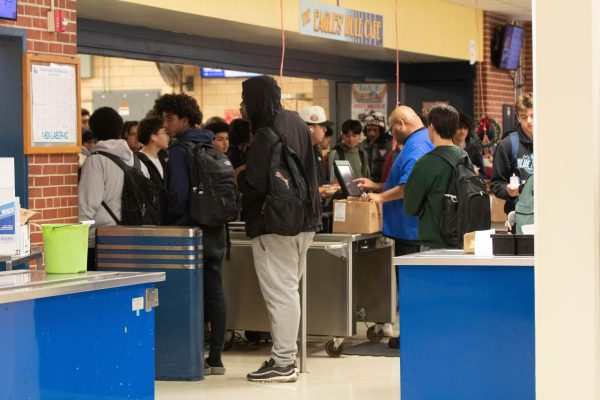 Students wait in long lines to grab their lunch.
