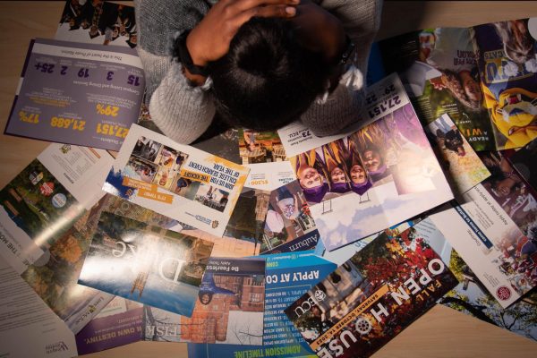 A student stressed from viewing the multiple college choices