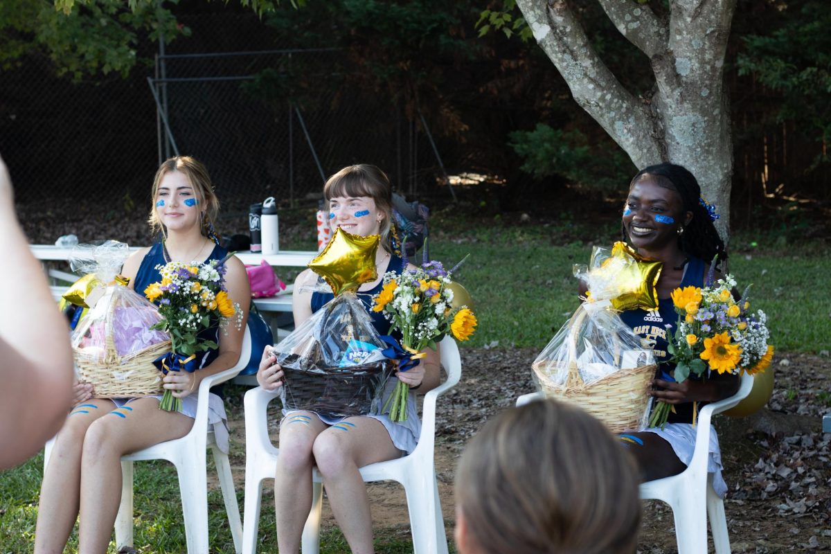 Lina Mercabi, Sydeny Uhlir, Makeda Bey hold their bouquets during senior night. 