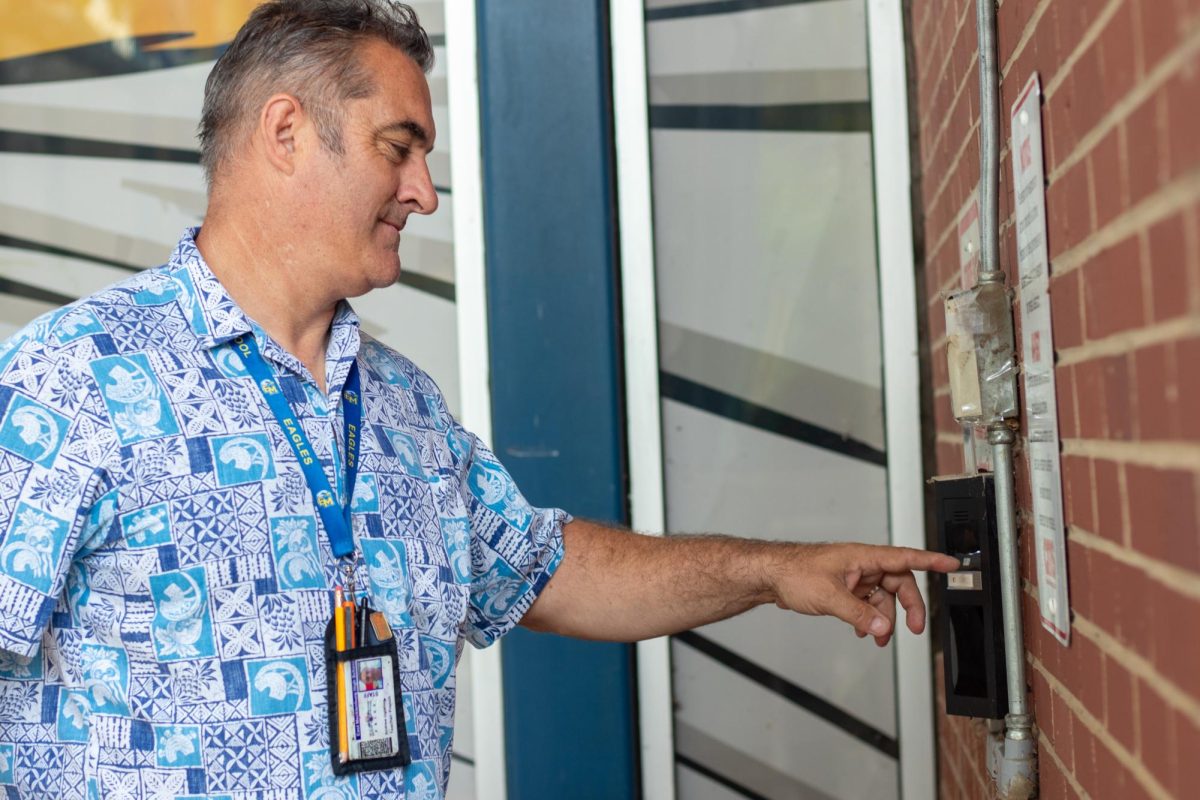 Mr. Uglehus demonstrates how the doorbell cameras would work. In order to gain access to building a student has to ring the doorbell and state why they're trying to enter. 