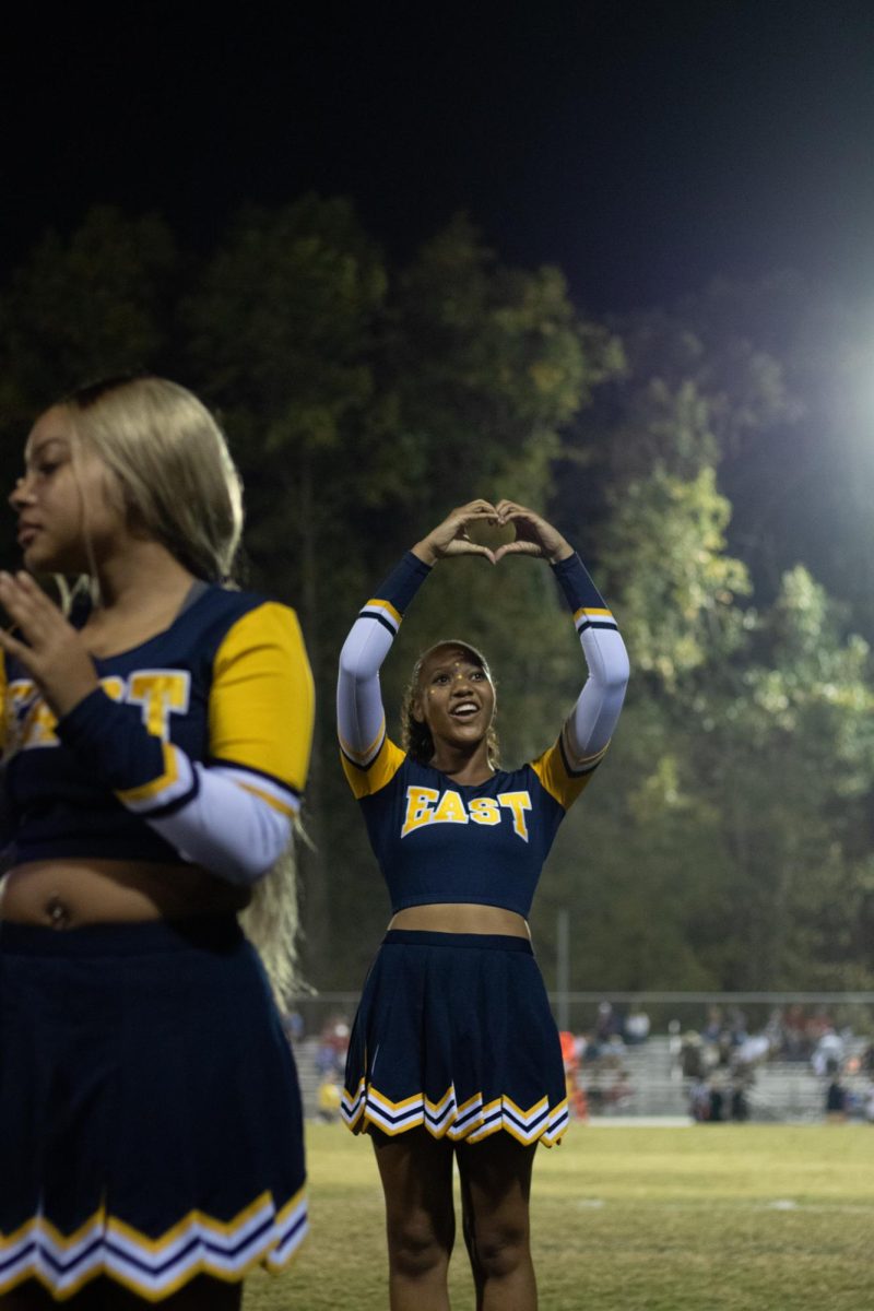 Nyla Wells shows love to her friends in the crowd after her cheer performance. 