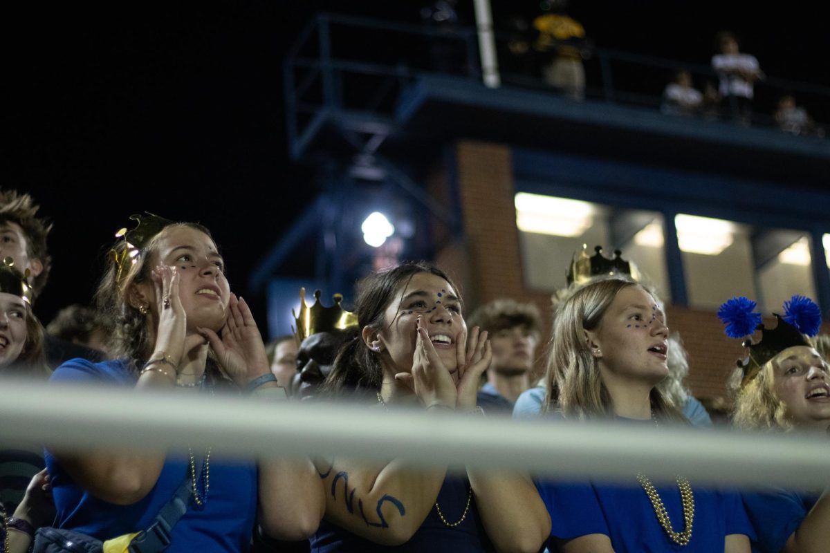 Kate Rogers, Kendall Holtzapple Blanton, Sarah Click and Ola Ombach cheer for East Meck football team during the homecoming game. 