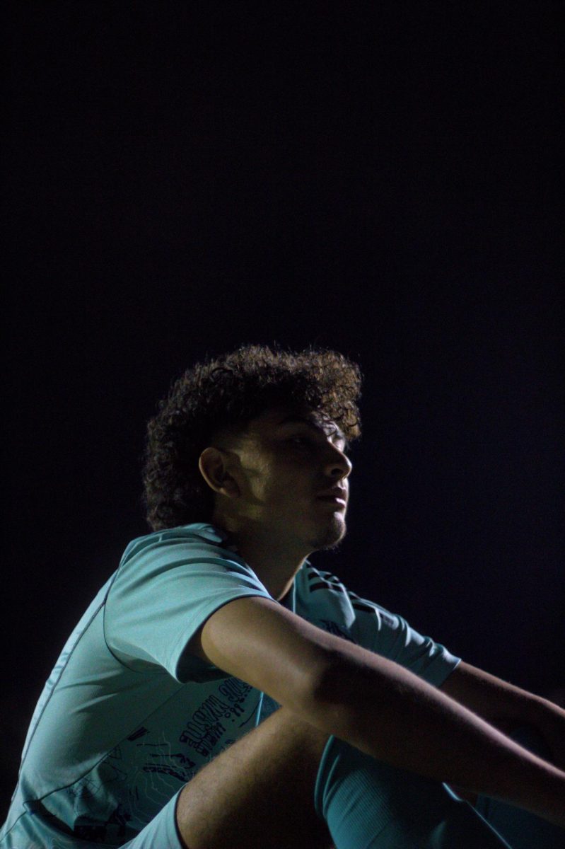 Jorge Gomez sits during halftime at a soccer game. Athletes use halftime as a time to relax and plan for the second half of the game. 