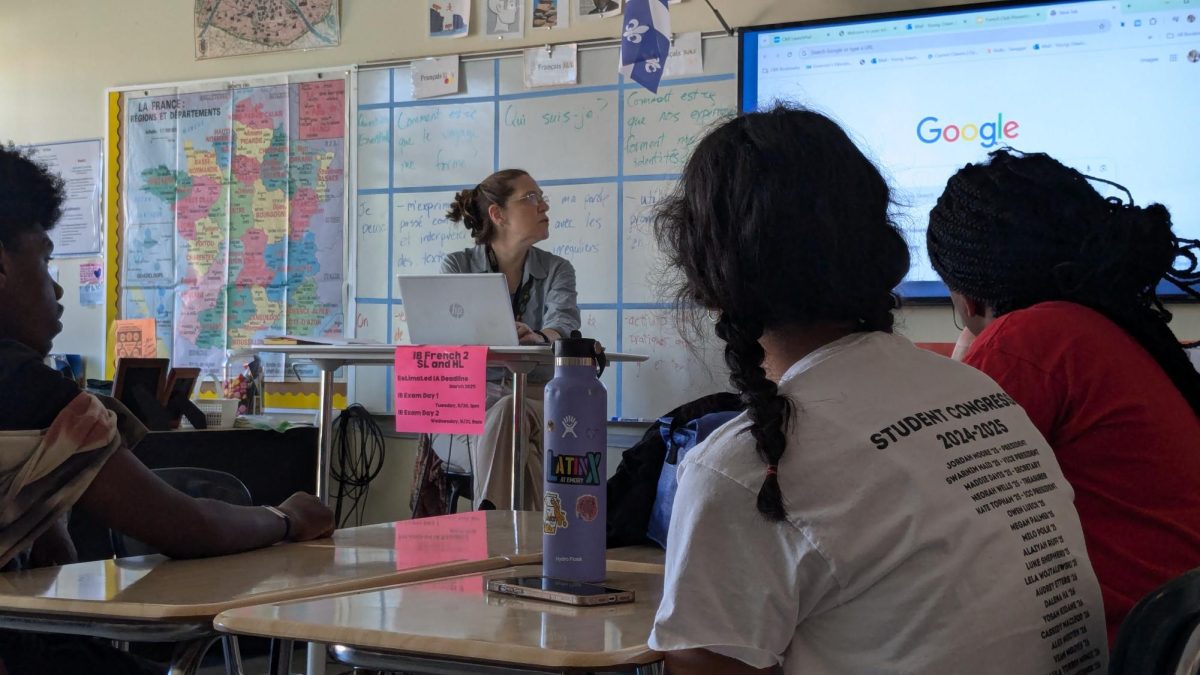 French teacher Dawn Young goes over a slide show with French Club members about the French Immersion Trip.