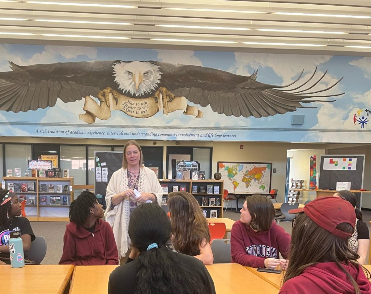  Media Coordinator Robin Williams discusses leadership positions with Battle of the Books club members.