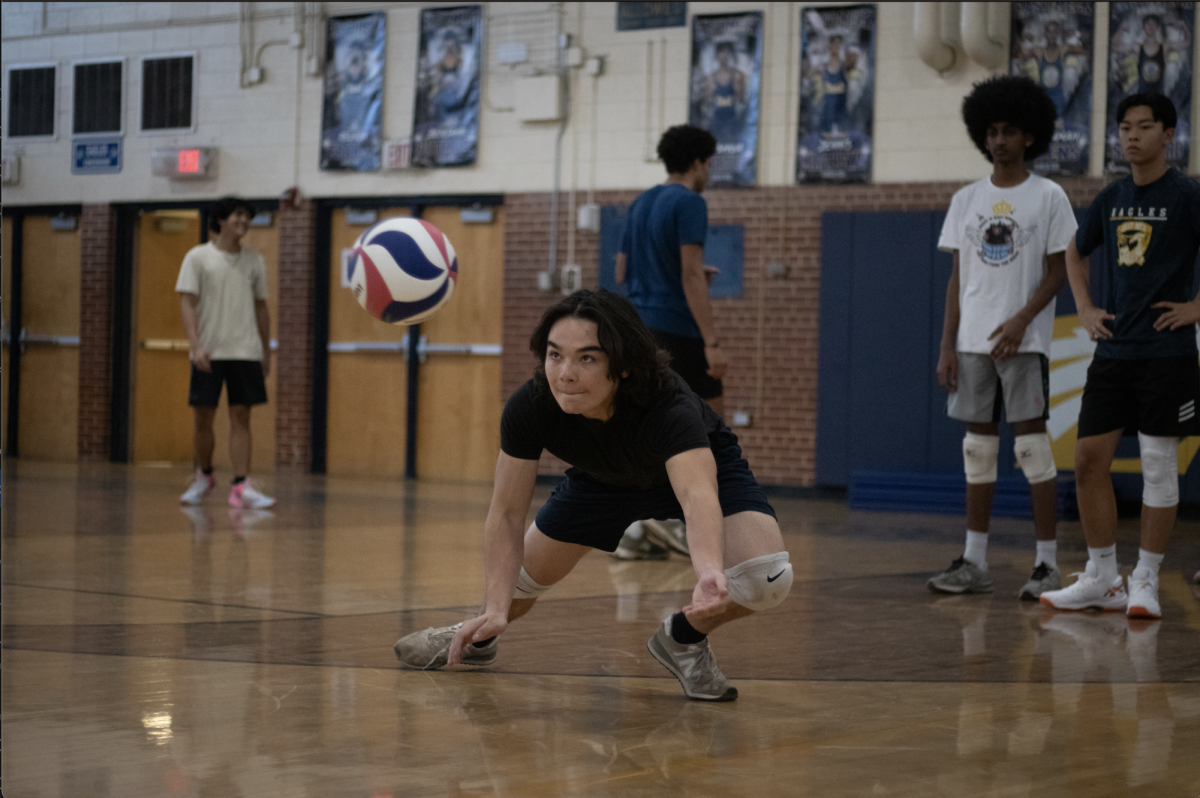 Tristan Hsin goes down for a dig during East Meck's mens volleyball first season tryouts.