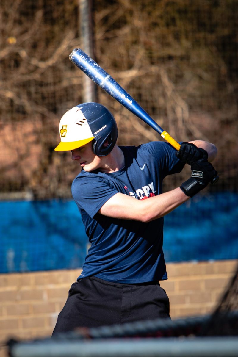 Gabe Johnson warms up his swing during baseball tryouts.