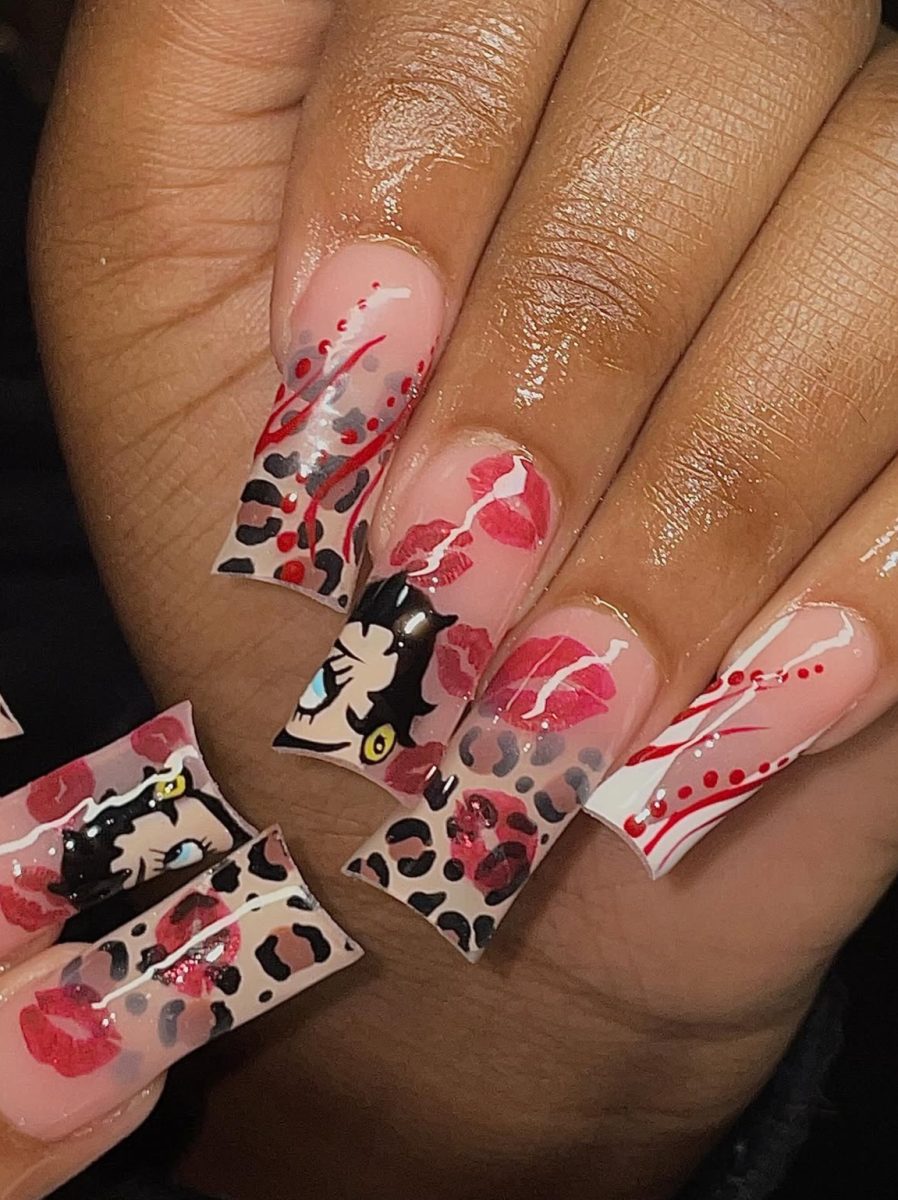 Nail artist Christina Win's client Martha Dawn shows off her nails. Outside of school, Win runs a nail business.