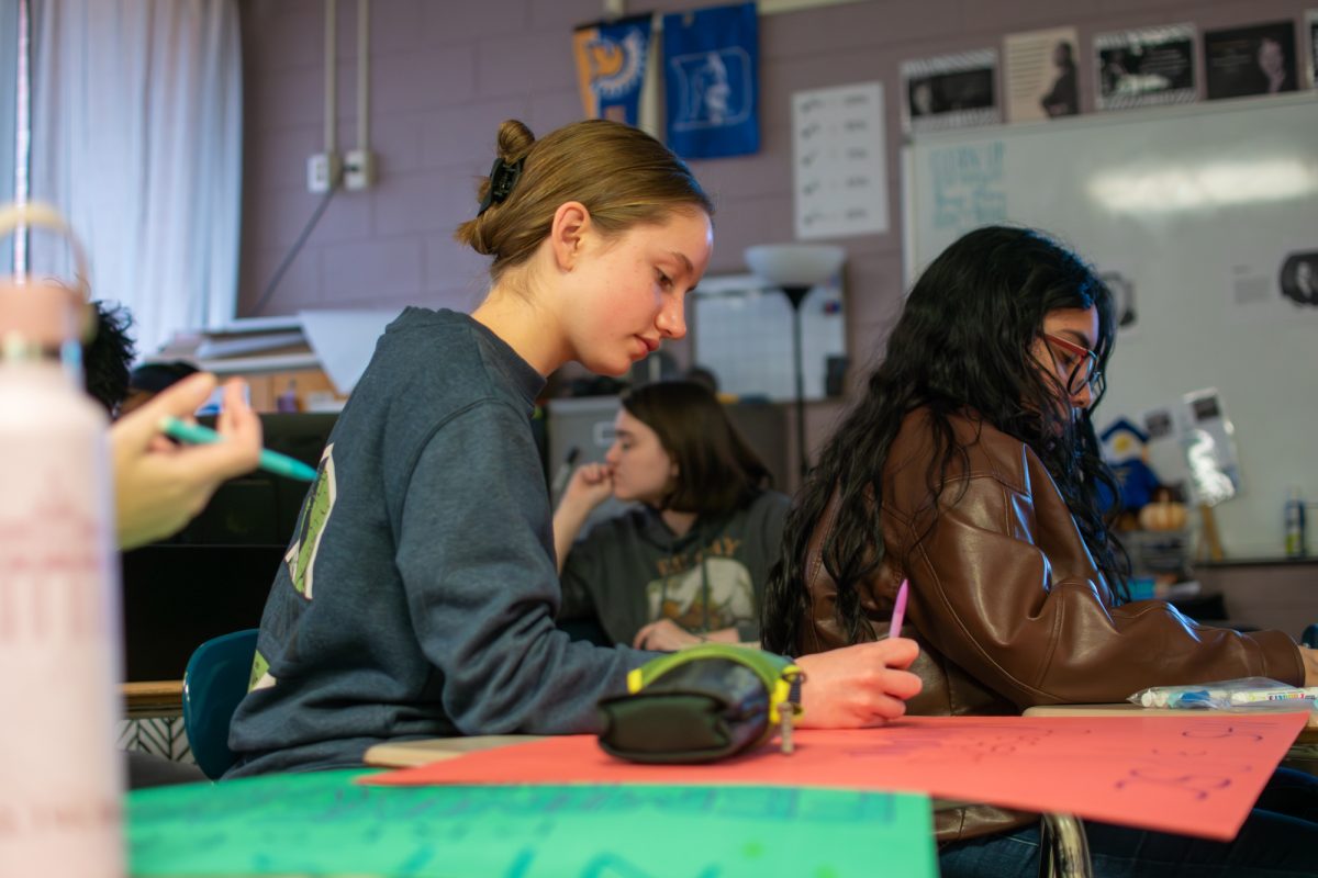 National Honor Society members Jeannie Fox and Sophia Garcia Lara, work o posters for an NHS feminine hygiene drive. East Meck's NHS has been very active this year, doing various projects and drives at the school as well as volunteering with outside organizations. 